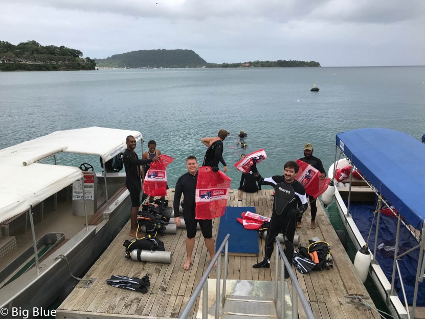 Armed with bags the divers get ready